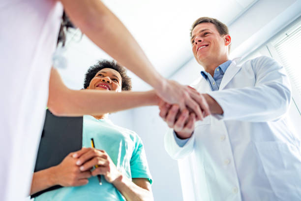 Male hospital chief of staff greets unrecognizable female job applicant Male hospital chief of staff greets unrecognizable female job applicant